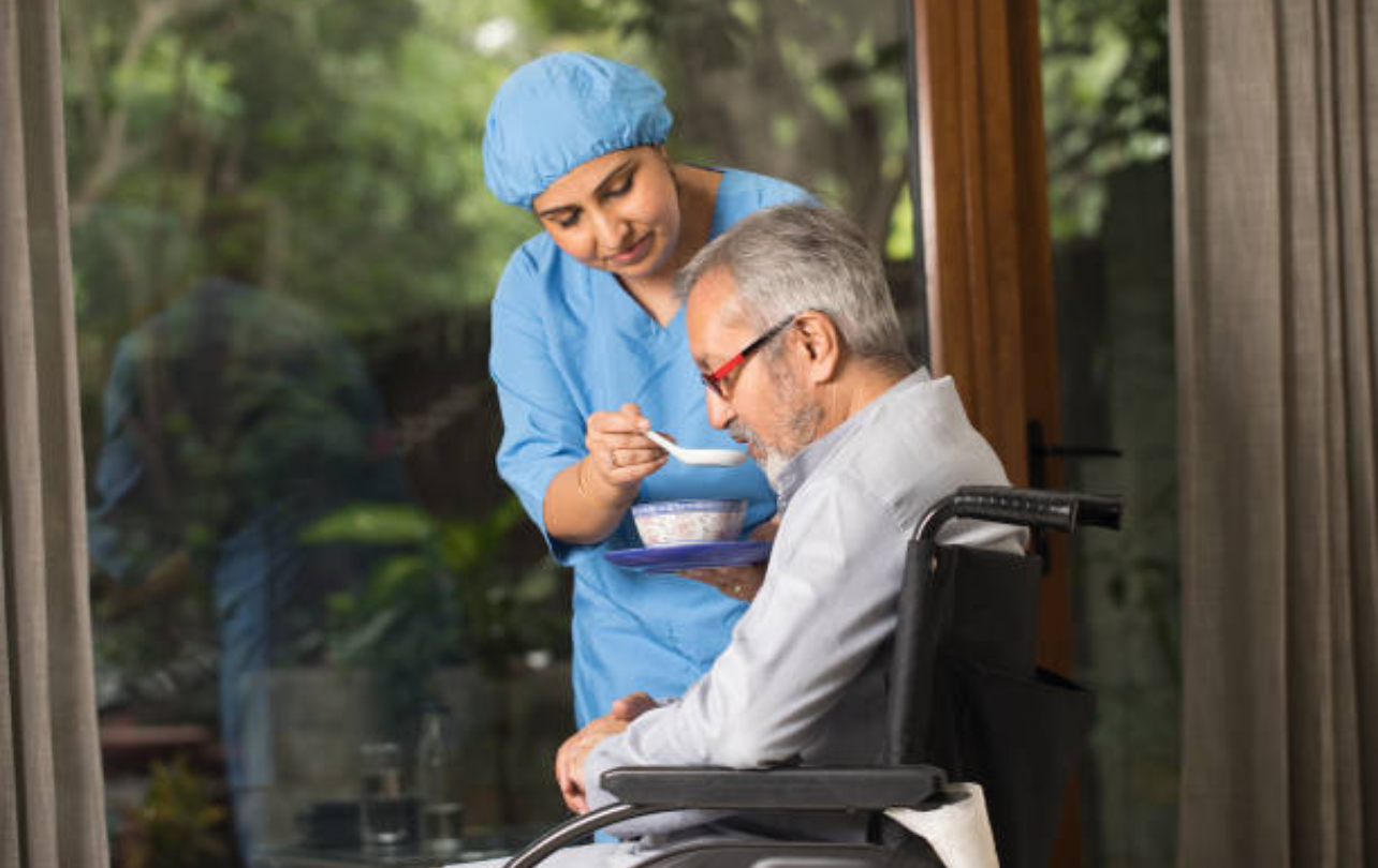 Home healthcare nurse caring for elderly patient at home