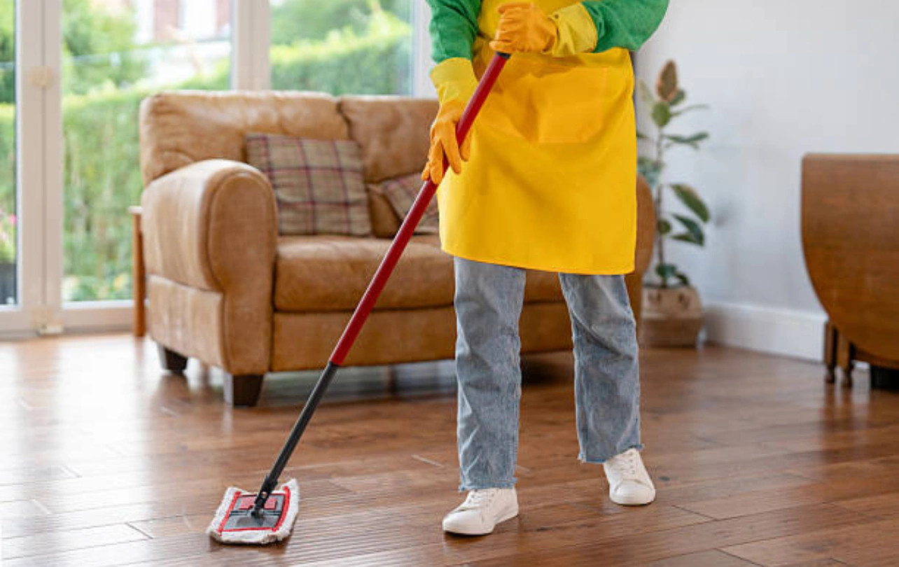 Home cleaning staff sanitizing living room in Trivandrum