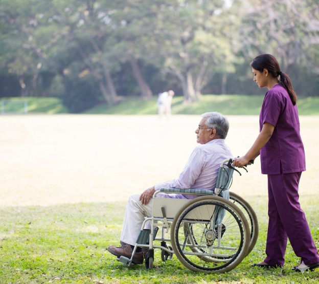 Home healthcare nurse assisting senior patient
