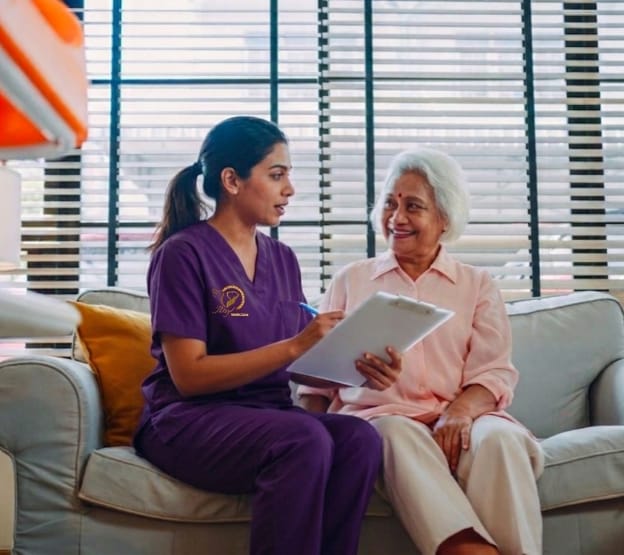 Nurse assisting elderly patient at home