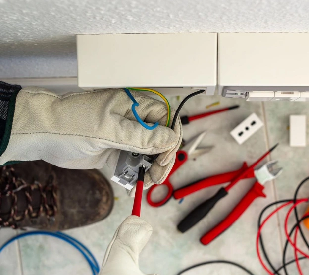 Professional repairing plumbing and electrical systems in a residential property